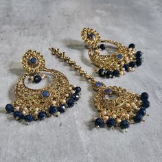 This listing is for Indian style Navy blue earrings and Maang Tikka set. These stunning earrings are crafted to enhance your style, whether you're attending a party or a wedding ceremony. They are guaranteed to make you stand out in the crowd. Elevate your style with these stunning dark blue earrings tika set. Make a bold fashion statement and turn heads wherever you go. Shop my stunning collection today! In addition to these earrings, I offer various hand-crafted Indian and Pakistani jewelry st Blue Desi Jewelry, Hand Set Hoop Earrings For Party, Elegant Dangle Chandbalis For Party, Party Jewelry Sets With Matching Drop Earrings, Elegant Festive Hoop Earrings For Party, Elegant Hand Set Chandbalis For Party, Festival Bridal Drop Earrings For Parties, Elegant Party Chandbalis With Hand Set, Elegant Party Chandbalis With Hand Set Details