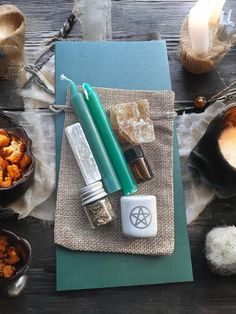 an assortment of items sitting on top of a table next to candles and other things