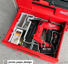 a red tool box filled with tools on the ground