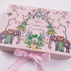 an elephant themed box with pink ribbon on the top and two elephants painted on it