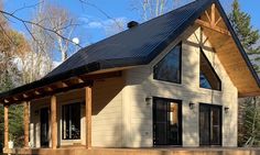 a house with a pitched roof in the woods