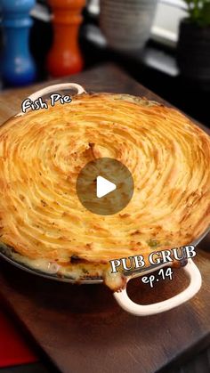 a pie sitting on top of a wooden cutting board