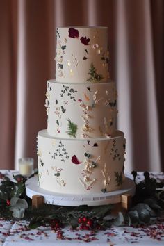 a three tiered white wedding cake sitting on top of a table