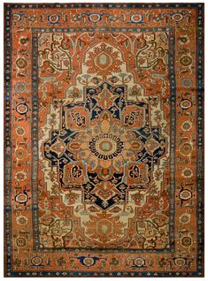 an orange, blue and black rug with ornate designs on the bottom half of it