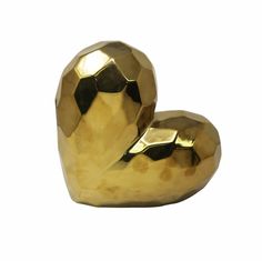 two golden heart shaped objects sitting next to each other