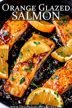 orange glazed salmon in a skillet with lemons and parsley