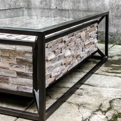 a coffee table made out of wood and metal with a stone pattern on the top