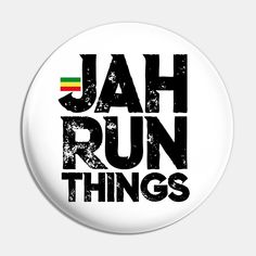 a white button with the words jah run things in black and red on it