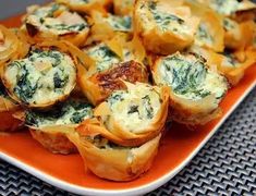 small appetizers with spinach and cheese on an orange plate