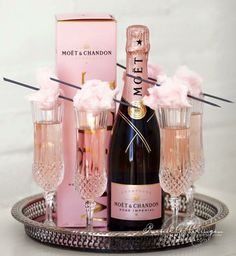 a bottle of champagne and glasses on a tray