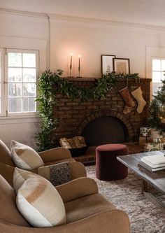 a living room filled with furniture and a fire place next to a christmas decorated tree