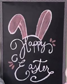 a chalkboard with the words happy easter written on it and an image of a bunny's head