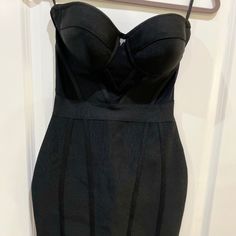 a black dress hanging on a hanger