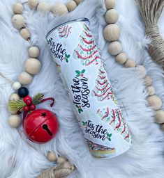 a can of water sitting on top of a white fur covered floor next to decorations