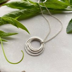 This elegant sterling silver necklace offers up a unique mix of minimalism and intricate rustic detail. Eight tiny circles are organically shaped & textured, then layered elegantly for a graceful swing from the sparkly sterling silver chain. It's the kind of necklace that she'll want to keep close to heart, for both the symbolism & the style. ✦ All metal is bright sterling silver.✦ Each circle is individually made by hand & and connected together with a soldered (sealed) jump ring.✦ Sterling Silver Full Circle Necklace For Anniversary, Minimalist Sterling Silver Necklace For Birthday, Milestone Birthday Gifts, Elegant Gift Wrapping, Small Drop Earrings, Birthday Necklace, Elegant Birthday, Necklace Extender, 80th Birthday