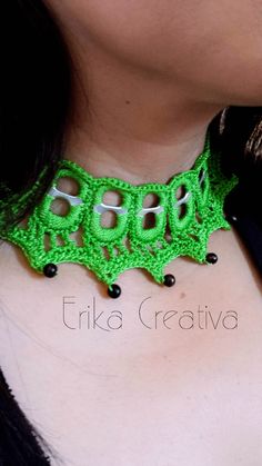 a woman wearing a green crochet necklace