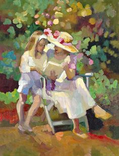 two women sitting on a chair in front of trees and flowers, one reading a book