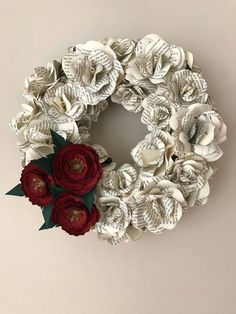 a wreath made out of book pages and paper flowers