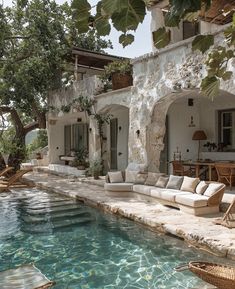 an outdoor living area next to a swimming pool