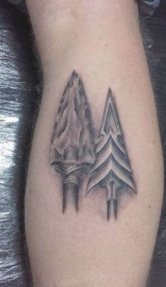 a black and white tattoo on the leg of a man with two trees in it