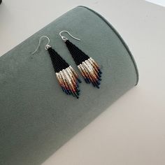 These matte black beaded earrings with ombre ivory fringe are made of high quality Japaneze and Czech beads. They are lightweight and comfortable. These beaded earrings are an amazing gift for special occasions: holidays, birthdays, anniversaries, Christmas, Valentine's Days and more.  This pair is a mix of ethnicity and modern casual style. I create for women who love to feel completely different. -------------------------------------------- ✦ The Details: ✔ Made with quality Czech beads ✔ Made using strong bead weaving thread.  ✔ Lenght: app. 3.1 inches ✔ Sterling silver earrings hooks There may be some color discrepancies which is due to the different monitor settings ✦ All  earrings hooks are nickel and lead free! ✦ More great boho earrings found here https://www.etsy.com/shop/LiliBead Bohemian Black Tassel Earrings As Gift, Black Bohemian Dangle Tassel Earrings, Bohemian Black Tassel Earrings With Dangling Beads, Black Beaded Bohemian Tassel Earrings, Black Bohemian Tassel Earrings, Black Beaded Earrings, Fringe Beaded Earrings, Festive Earrings, Earring Inspo