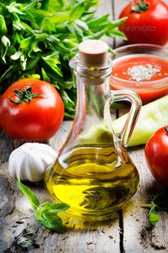 an assortment of vegetables and oil on a wooden table - stock photo - images in gallery