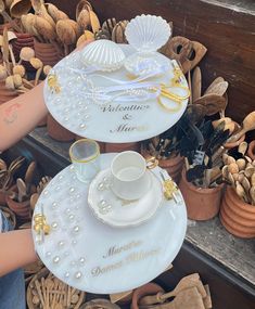 there are two plates that have been decorated with pearls and gold trimmings on them