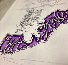 a close up of a piece of paper with the word love written in purple ink