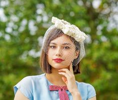 "DESCRIPTION * vintage hat from 1950s-1960s * halo headband style: ringlet headband, halo crown covers part of the head * the band is made with off-white-light cream bows which form a star shape when looked from the top * comes with veil * embellished with an off-white thermostat hat pin * will need a hair pin to secure the hat * no tag This hat will be steamed, reshaped, and stuffed with proper paper before putting in a box. However, this type of veil will get wrinkled and will probably need to Vintage Wedding Fascinator Headband, Vintage Wedding Headband Fascinator, Vintage Headband For Kentucky Derby, Whimsical Round Crown Headband For Wedding, Vintage Headpieces For Wedding And Kentucky Derby, Retro Adjustable Headpieces For Wedding, Vintage Wedding Headpiece For Kentucky Derby, Retro Adjustable Wedding Headpiece, Vintage Mini Hat Headband For Vintage Events