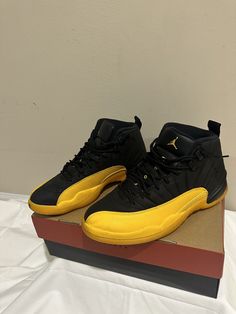 Elevate your sneaker game with this stylish and sleek Jordan 12 Retro in the University Gold colorway. The shoe features a black base with gold accents, giving it a classic yet trendy look that will surely turn heads. Designed for athletic performance, these sneakers are perfect for anyone looking to step up his/her shoe game. These shoes have been gently used and are in excellent condition, ready to be worn by their next owner. With a UK shoe size of 9.5 and a US size of 10.5, this Jordan 12 Retro is a must-have for any sneaker enthusiast. Add this to your collection now and experience the comfort, performance, and style that Jordan sneakers are known for. Jordan 12 Taxi, Jordan 12 Retro, Jordan 12, Jordans 12, Jordan Sneakers, Sneaker Games, Athletic Performance, Shoe Game, Jordans Sneakers