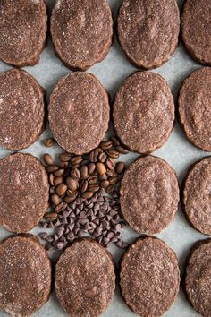 chocolate cookies and coffee beans are arranged on a baking sheet