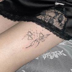 a woman's thigh with tattoos on her legs and the word love written in black ink