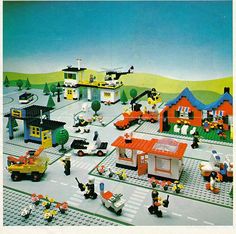 there is a lego town with cars and people on the street in front of it