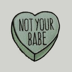 a green heart with the words not your babe on it