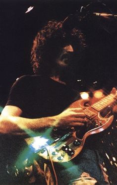 a man playing an electric guitar on stage