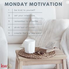 a table with a book, coffee cup and ring on it next to a white couch