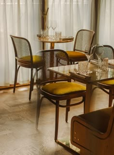 a dining room table and chairs in front of a window