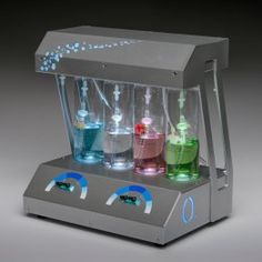 a machine that is filled with different colored liquids and flasks on top of it