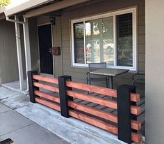 the front porch is made out of wood and metal