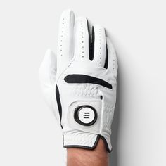 a man's hand wearing a white golf glove with black trimmings on it