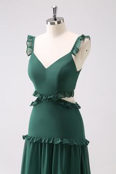 a green dress on a mannequin with ruffles around the bust and shoulders