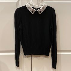 Black Maje Sweater With White Jeweled Collar. Size Fr 1 Corresponds To Us 0-2. Please Note There Is Some Light Beige Discoloration On The Inside Of The Collar. This Is Not Visible When Wearing. Black Long Sleeve Tops With Embellished Collar, Black Long Sleeve Top With Embellished Collar, Jeweled Collar, Black Sweater, Light Beige, Black Sweaters, Sweaters For Women, Black White, Black And White