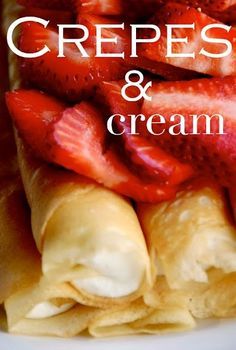 crepes and cream with strawberries on top are piled up in a white plate