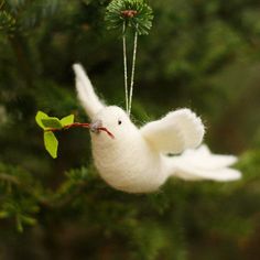 a white bird ornament hanging from a tree