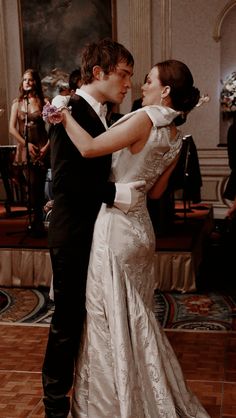 a bride and groom are dancing together at their wedding