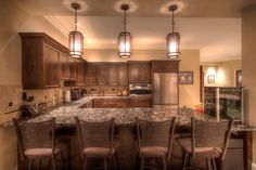 a kitchen filled with lots of counter top space next to a dining room table and chairs