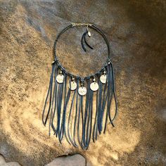 -This Western-inspired bib necklace features soft black deerskin leather and authentic Buffalo Nickels, accented by pyrite stones.-A versatile statement piece, this fringe necklace is equally stunning as festival wear, western wear, or paired with your favorite dress.-The Buffalo Nickel, also known as the "Indian Head Nickel" was minted in the United States from 1913 - 1938.  Buffalo Nickels portray the profile of a Native American chief on one side and an American Bison on the other side.-Exact Western Americana, Southwestern Necklace, Native American Chief, American Bison, Buffalo Nickel, Indian Head, Fringe Necklace, Bib Necklaces, Deer Skin