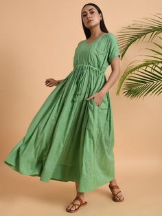 A free size long maxi dress with drawstring at the waist and double pockets Garment measurements (in Inches): Free Size: Bust: 50", Waist: 48", Length: 52" Fabric: Cotton Dobby Color: Green Fit: Model height is 5'7" Model is wearing a size S Loose and comfortable fit. Instructions: Hand wash separately in cold water Note: Available in other colors Pants not included with the product Pants can be bought separately This product will be shipped within 20-25 days of order placed. Long Maxi Dress With Pockets For Beach, Maxi Length Drawstring Dress For Vacation, Beach-ready Long Maxi Dress With Pockets, Long Beach Maxi Dress With Pockets, Beach Maxi Dress With Pockets, Spring Maxi Dress With Drawstring, Vacation Maxi Dress With Pockets, Short Sleeve Maxi Dress With Pockets For Vacation, Green Beach Maxi Dress With Pockets