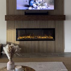 a living room with a fireplace and television above the fire place in front of it