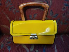 This fun, funky, art deco leather pocketbook with a 9" X 9" X 3.5" with fixed handle which extends 3.5" above the top of the bag is a great addition to a fun wardrobe.  With ample space and an inside zippered pocket to carry your particulars. Retro Yellow Rectangular Shoulder Bag, Retro Top Handle Satchel As Gift, Vintage Formal Satchel With Adjustable Handle, Vintage Yellow Rectangular Shoulder Bag, Retro Handheld Satchel With Detachable Handle, Top Handle Bags, Yellow Art, Vintage Purses, Pocket Book